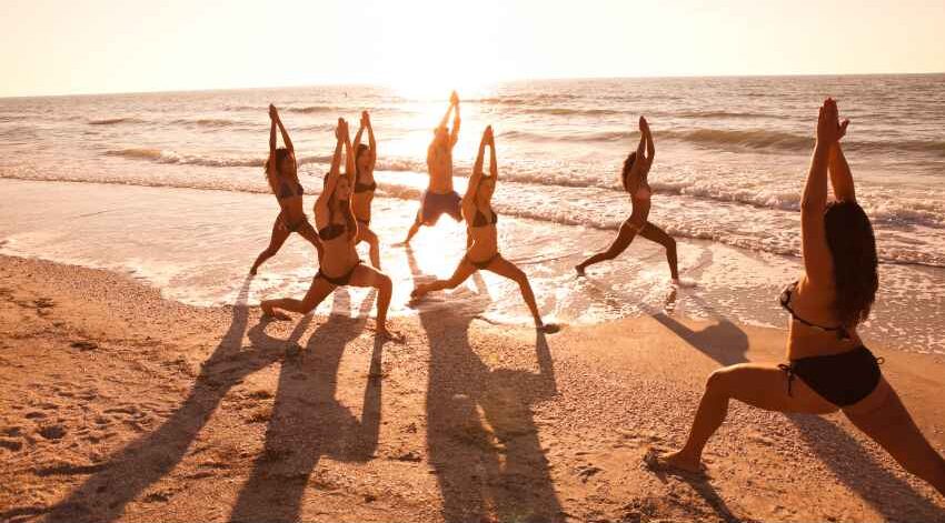 Joining a yoga class by the sea is a great way to exercise while on holiday