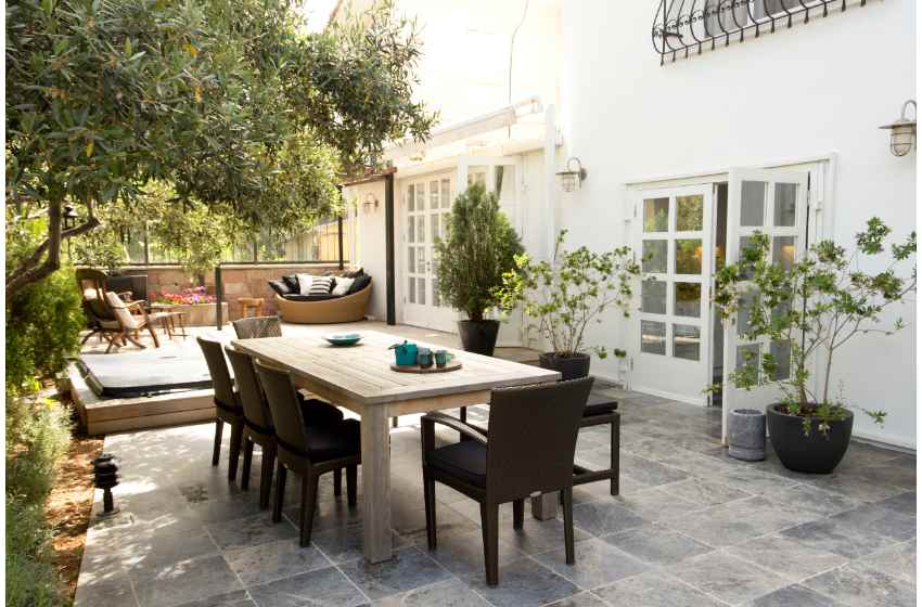 A comfortable outdoor living space with seating options and planting