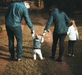 Family walking young children in the park to support family wellness